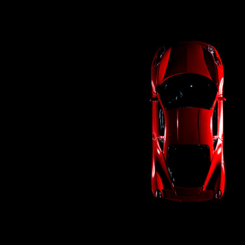 Izmir, Turkey - August 1, 2015: Red sports car like ferrari but not. Its brandless. On a black background and low key image.